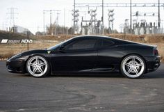 a black sports car parked in a parking lot