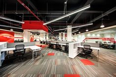 an empty office with desks and chairs