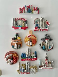 a refrigerator with magnets on it that are decorated like cities and famous landmarks, including the statue of liberty