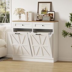 a white cabinet with doors and drawers in a living room