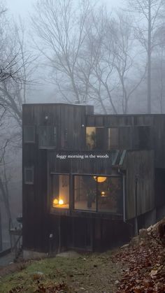 a house made out of shipping containers in the fog