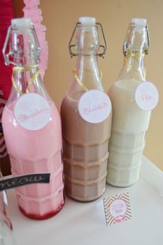 three empty milk bottles sitting on top of a table