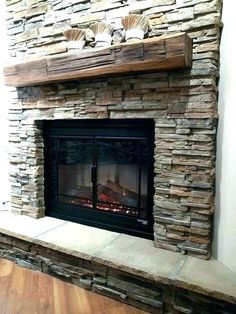 a stone fireplace is shown in this living room