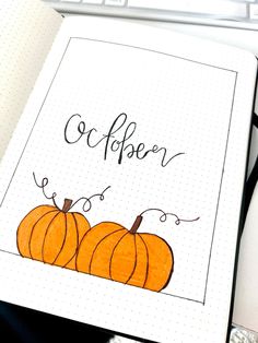 an open notebook with two pumpkins on it and the words october written in cursive writing