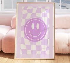 a purple smiley face poster in front of a white couch