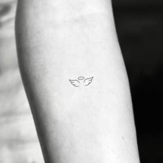 a person with a small tattoo on their arm