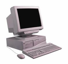 an old computer with a mouse and keyboard