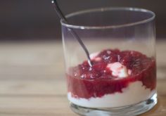 a small glass filled with food on top of a wooden table