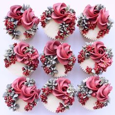 twelve cupcakes decorated with pink and silver flowers