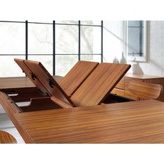 a wooden table with two open drawers on it