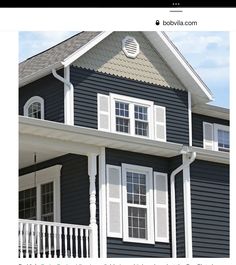 a blue house with white shutters and balconies is featured in the magazine bobballa com