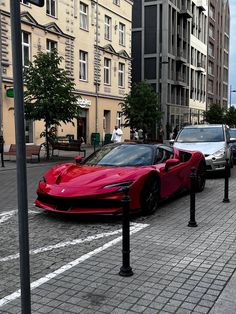 a red sports car is parked on the street