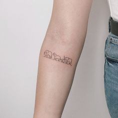 a woman's arm with an elephant tattoo on the left side of her arm