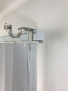 an image of a shower door handle attached to the side of a bath room mirror