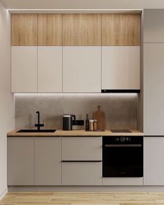 a kitchen with white cabinets and black appliances