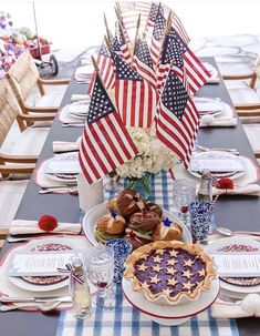 a patriotic table setting with american flags and pies