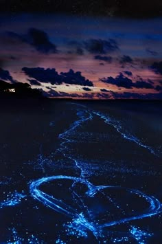 the sky is lit up with blue lights as it looks like an image in the water