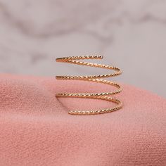 This beautiful Twisted Rope Double Spiral Ring can be made from Sterling Silver, 14K Gold Fill, or 14K Rose Gold Fill. The ring is shined to a mirror finish and is a beautiful piece of jewelry that stands out boldly, while still remaining minimalistic. The ring is adjustable and holds it's shape well, with the ability to be squeezed together for closer coils. Spiral Rings Gold, Coil Ring, Spiral Ring, Gold Wrap, Hammered Rings, Bypass Ring, Golden Jewelry, Monogram Jewelry, A Mirror