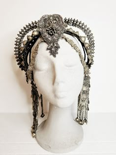 Indulge your inner goddess with this exquisite Afghan tribal headpiece, a bold statement piece that exudes power and elegance. Handcrafted with a mix of intricate beads, embroideries, vintage rhinestones, and luxurious vegan leather, this stunning headpiece is a true work of art. Whether you're heading to a festival, a stage show, or a special performance, this headpiece is designed to make you stand out from the crowd with its captivating glamour and tribal allure. Crafted for comfort and light