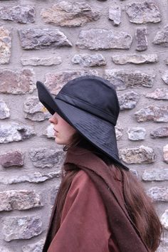 "The 'Storm Chaser' is based on the traditional form of collapsible Waxed Cotton Sou'westa rain hat that is longer in the back than the front to protect the neck fully. The hat has a roll up brim at the front which works like a gutter whilst keeping the face clear. The brim extends down the back, bridging and protecting the neck.  The 'Storm Chaser' is the perfect choice for women who have to be out in the worst weather but want to be looking their best.  Because the brim is large there are adde Winter Sun Hat, Rain Hats For Women, Waterproof Brimmed Bucket Hat For Travel, Waterproof Solid Color Wide Brim Sun Hat, Weatherproof Curved Brim Hat For Travel, Adjustable Waterproof Brimmed Hats, Adjustable Black Waterproof Sun Hat, Solid Wide Brim Waterproof Bucket Hat, Waterproof Bucket Hat With Curved Brim