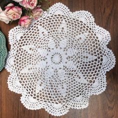 a white doily sitting on top of a wooden table