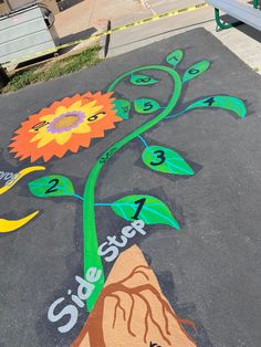 the sidewalk has been painted with flowers and numbers on it for children to learn how to draw