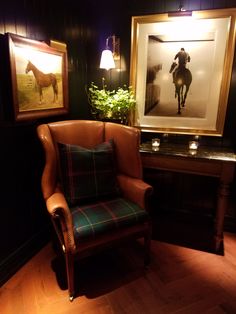 a chair in a room with pictures on the wall