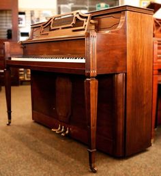 an old piano sitting in the middle of a room