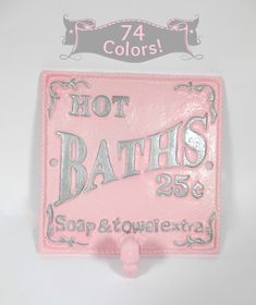 a pink sign that says hot baths on it