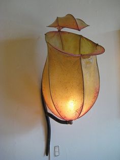 a lamp hanging from the side of a wall