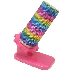 a spool of colorful thread sitting on top of a pink stand with a white background