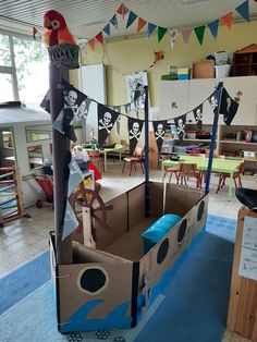 an open cardboard box with pirate decorations on the top and sides, in a classroom setting