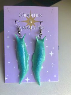 These slimy looking slugs are perfect for lovers of creepy crawlers. Charge them in the light and watch them glow!  I am able to make almost any color glow, so feel free to message me if you're interested in a custom order.  Please note:  All of my items are handmade to order. This means you will receive a unique, one-of-a-kind item that may differ slightly from the photos. Please allow extra processing time while I perfect your order! Polymer Clay Slug, Creepy Clay Earrings, Weird Clay Earrings, Cool Clay Earrings, Clay Slugs, Unique Polymer Clay Ideas, Polymer Clay Ideas Aesthetic, Polymer Clay Bugs, Clay Slug