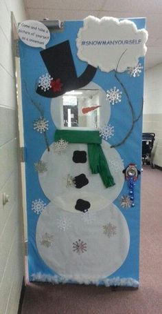 a door decorated like a snowman with a hat and scarf