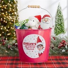 an elf's christmas cheer bucket with stuffed animals