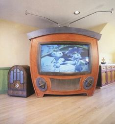 an old tv sitting on top of a hard wood floor