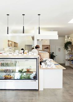 the inside of a store with people working behind the counter