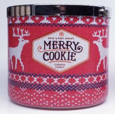 merry cookie tin with reindeer on red and white knitted fabric, in front of a white background