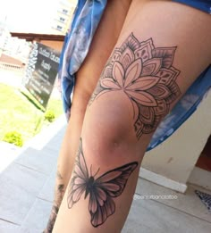 a woman's leg with a butterfly tattoo on it and the bottom part of her thigh