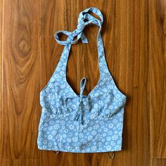 New Without The Price Tag (Plastic Tag Holders Still Attached). Hollister Halter Top In The Size Xs! This Top Features A Baby Blue Color With A White Floral Pattern, An Adjustable Halter Neckline, And Smocking Detail Along The Back. Size - Xs Pit To Pit - 13” Pit To Bottom Hem - 8” Slight Stretch Due To Smocked Back Panel Blue Cotton Tops With Tie Back, Blue Tie Back Top For Vacation, Blue Summer Tops With Tie Back, Summer Blue Tops With Tie Back, Fitted Light Blue Summer Top, Cute Halter Tops, Fashion Definition, Halter Top Pattern, Cropped Halter Top