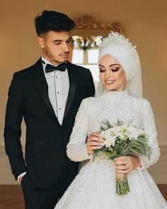 a man in a tuxedo standing next to a woman in a wedding dress