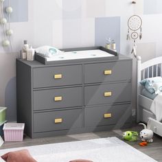 a baby's room with a crib, dresser and bed