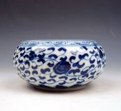 a blue and white bowl sitting on top of a table