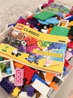 a plastic container filled with lots of legos