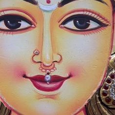 a painting of a woman's face on the side of a building in india