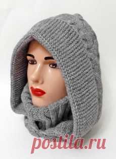 a mannequin's head wearing a gray knitted hat with a hood