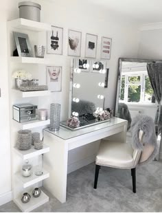 a white desk and chair in a small room with pictures on the wall above it