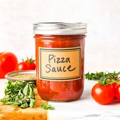 a jar of pizza sauce next to some tomatoes