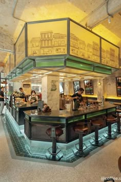 the inside of a restaurant with tables and stools