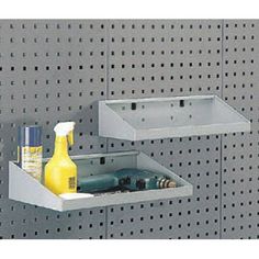 two bins with bottles and other items in them on a peg board wall mounted shelf